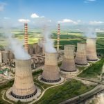 Un groupe de cheminées avec de la fumée qui en sort.